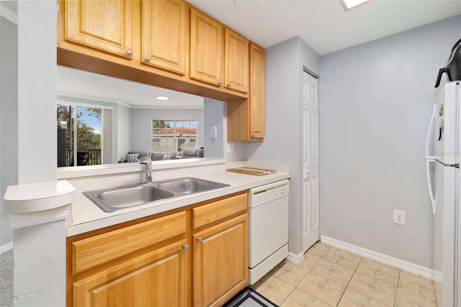 5500 BENTGRASS DRIVE, #6-203, Sarasota, FL 34235 Kitchen with Living Room View.