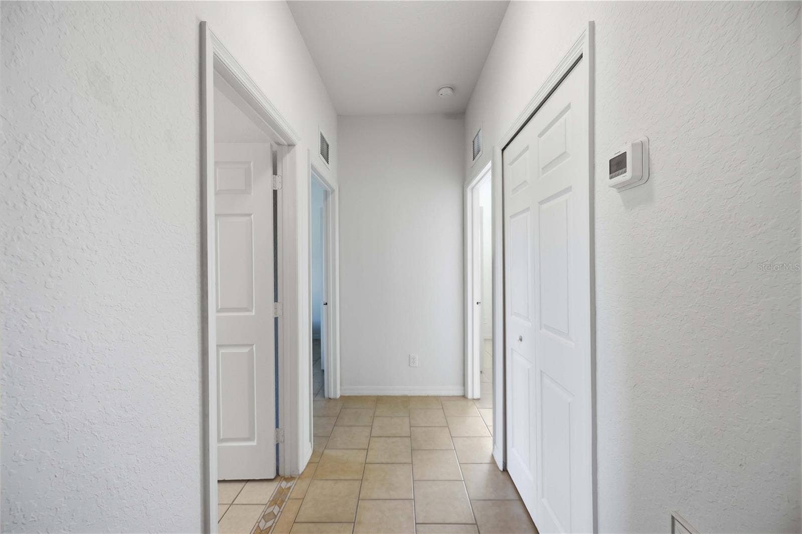 1150 KNOTTY PINE AVENUE, North Port, FL 34288 Split floor plan, hallway to the two bedrooms