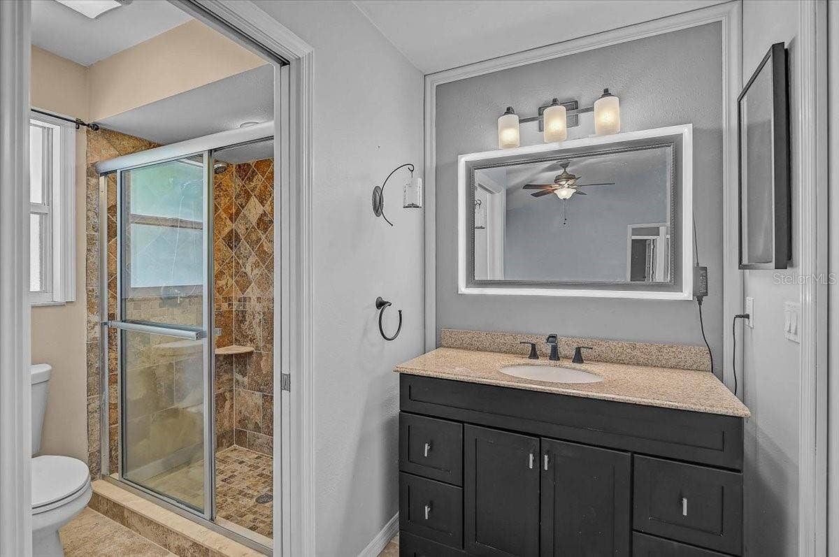 7739 33RD LANE E, Sarasota, FL 34243 Primary Bathroom and Smart mirror custom color light frame.