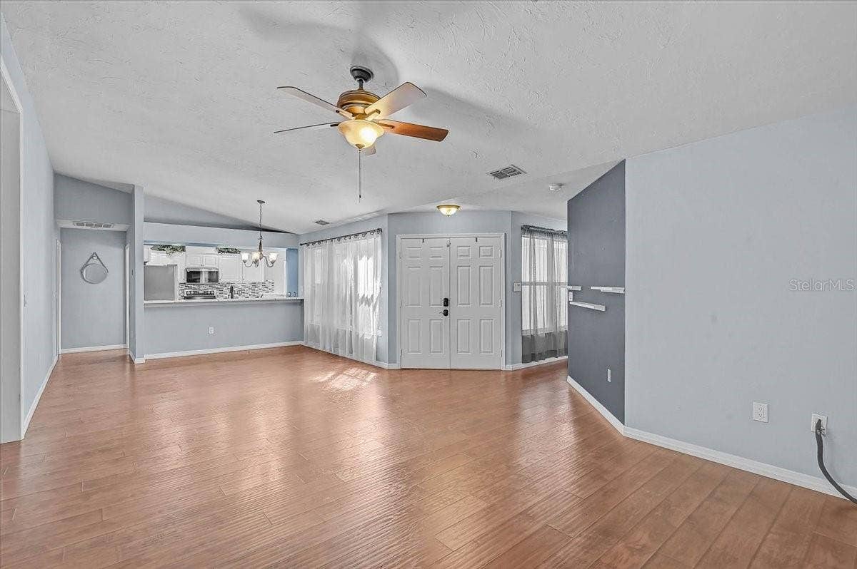 7739 33RD LANE E, Sarasota, FL 34243 Living Room, Dining Room, Kitchen. Front Double Doors.