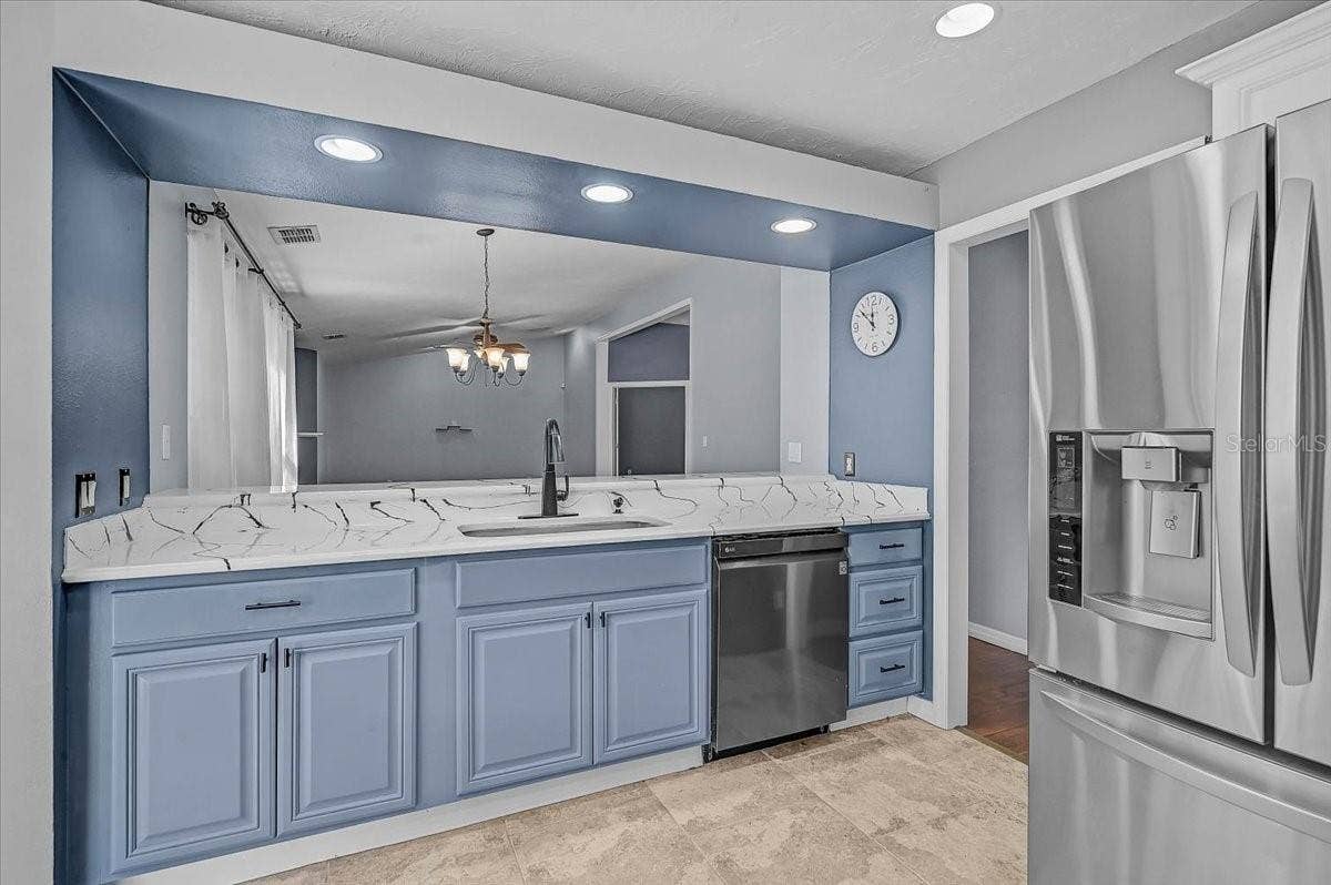 7739 33RD LANE E, Sarasota, FL 34243 Kitchen Looking into Dining Room and Living Room.