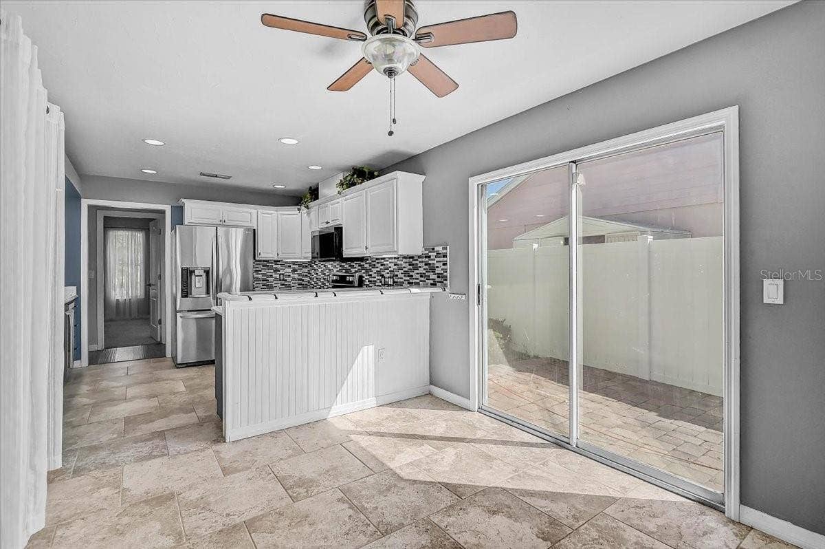 7739 33RD LANE E, Sarasota, FL 34243 Dinette Looking into Kitchen and Side Patio 35' x 9'