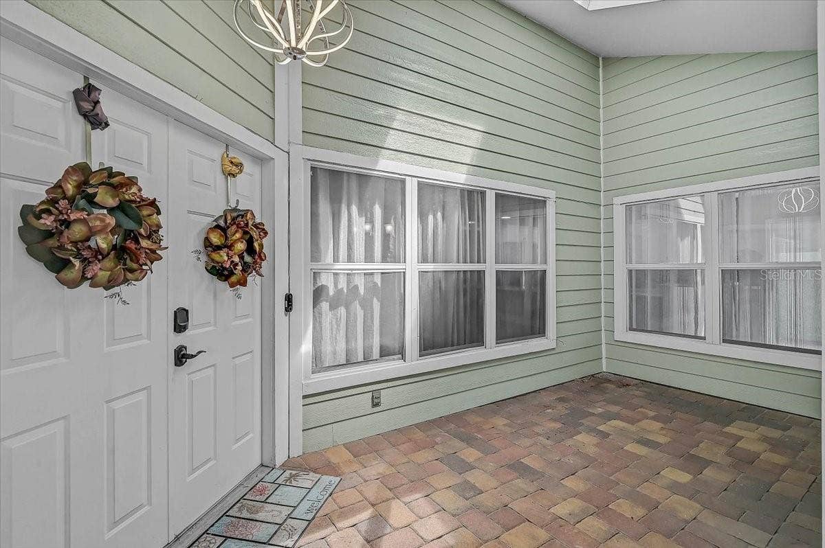 7739 33RD LANE E, Sarasota, FL 34243 Covered Patio Outside Front Door 19' x 8'