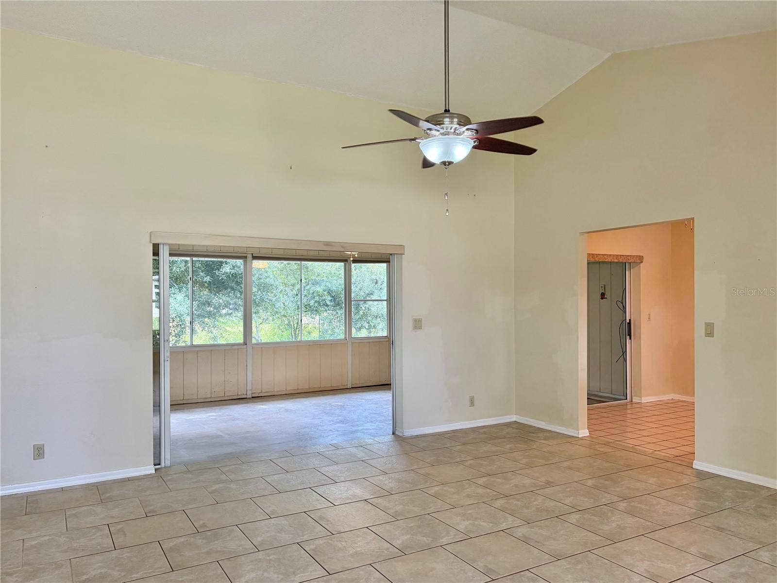 LR has a Ceiling Fan on a Vaulted Ceiling
