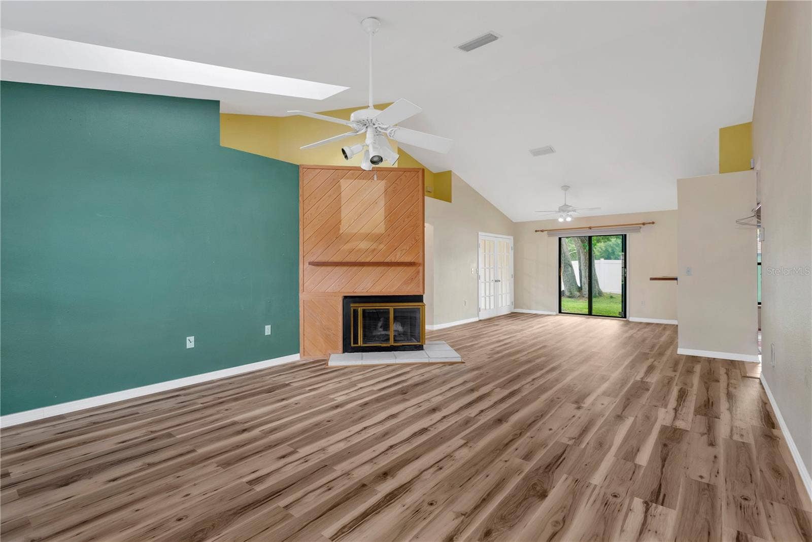 5546 34TH COURT E, Bradenton, FL 34203 Living Room, Dining Room and French Doors leading into Office. Sliders leading out to patio in backyard.