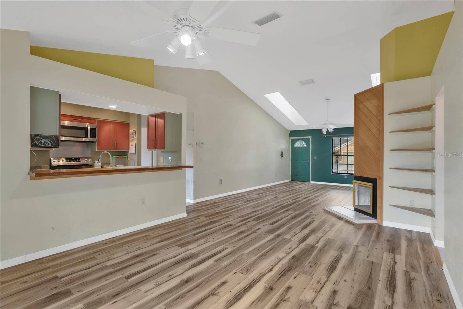 5546 34TH COURT E, Bradenton, FL 34203 Dining Area with ceiling fan, looking at pass-through with bar into kitchen - convenient and great for entertaining