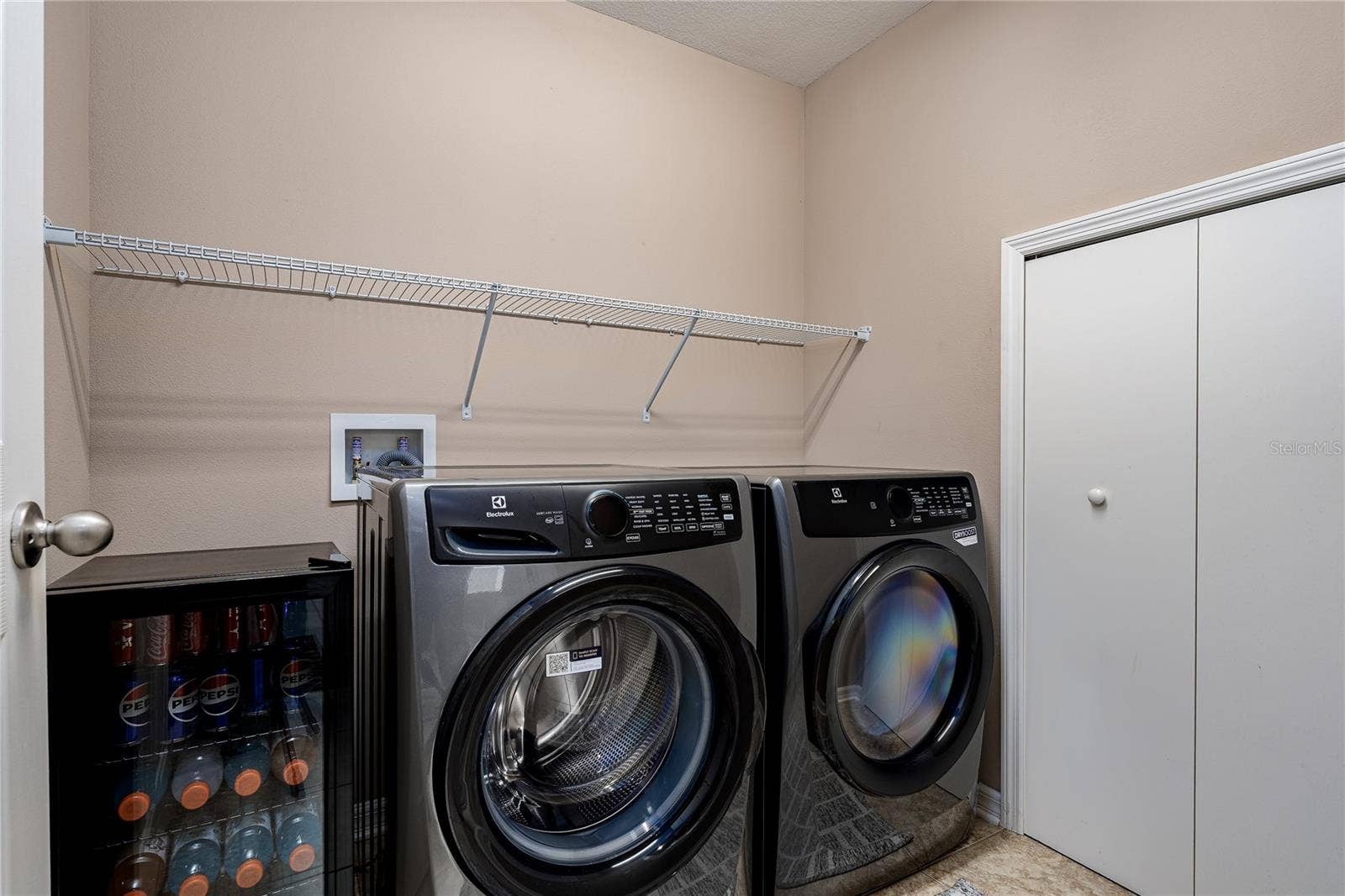5918 OAK MILL TERRACE, Palmetto, FL 34221 Laundry room with extra storage space under the stairs