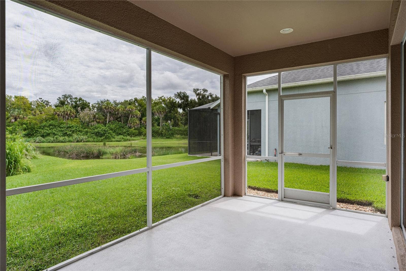 5918 OAK MILL TERRACE, Palmetto, FL 34221 Screened porch with pond and preserve view