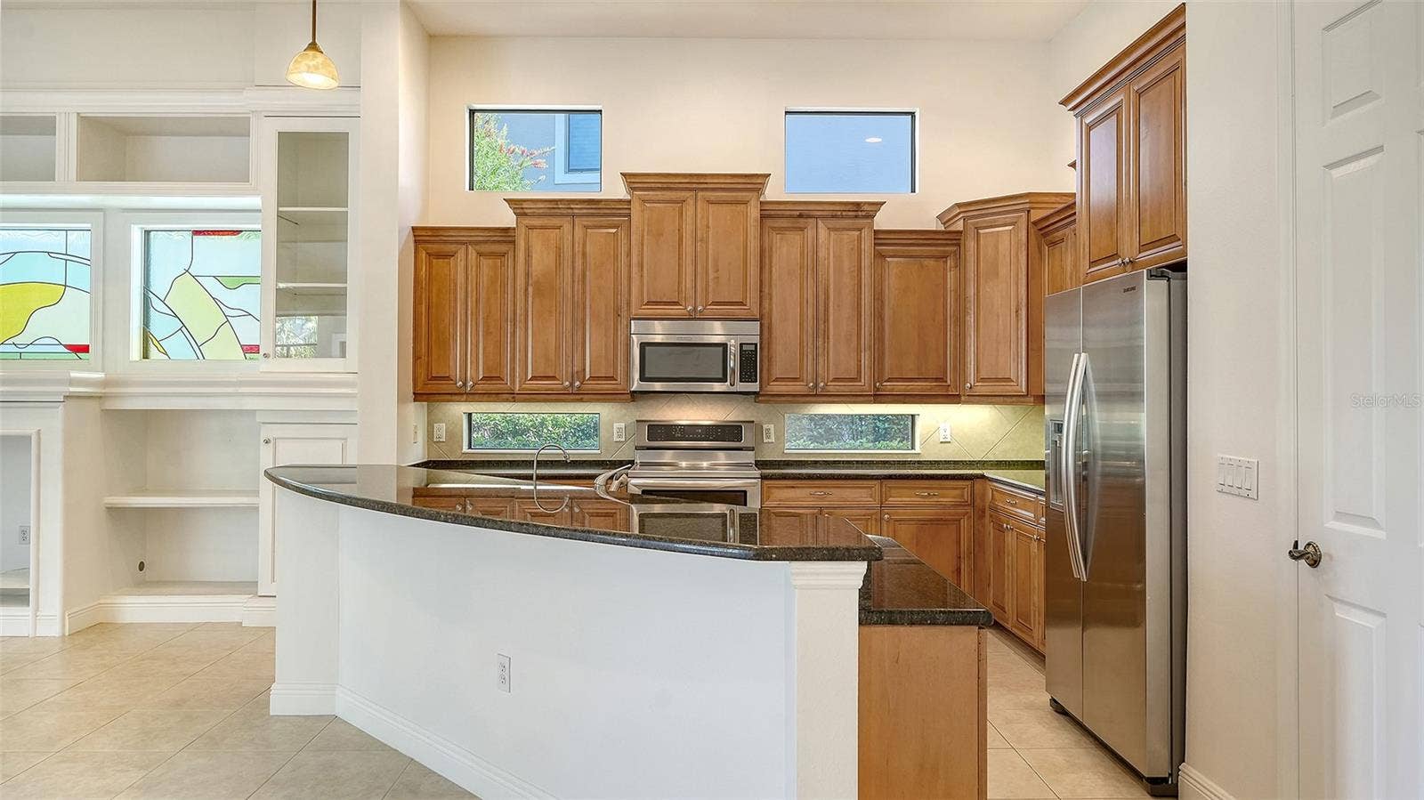 13978 SIENA LOOP, Lakewood Ranch, FL 34202 Spacious kitchen with newer appliances including an induction range.