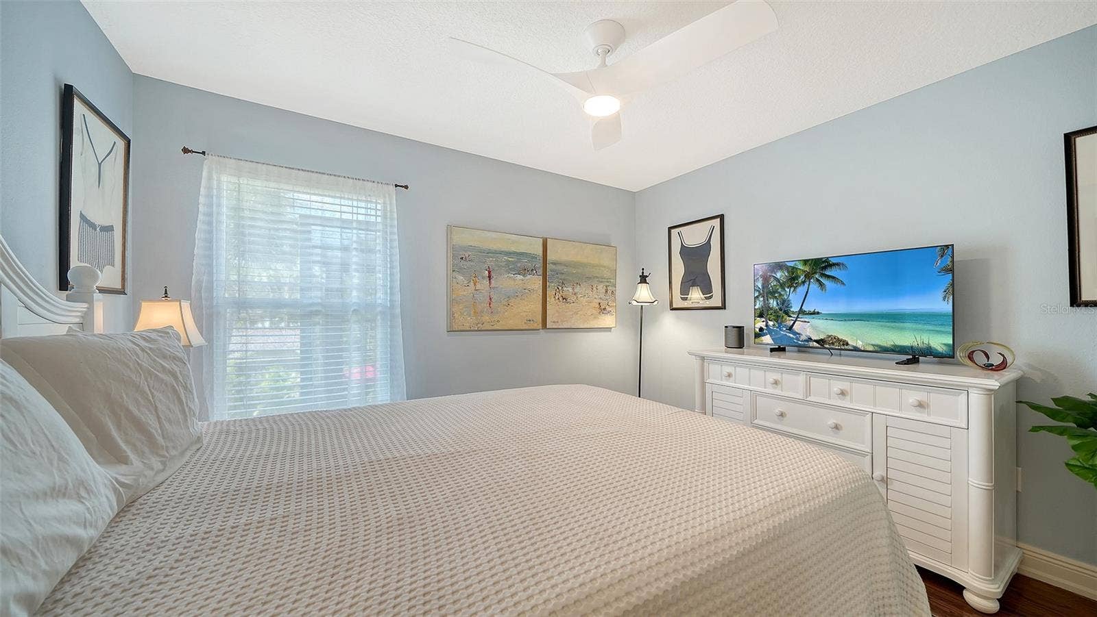 Spacious guest bedroom with ceiling fan and generous closet space.