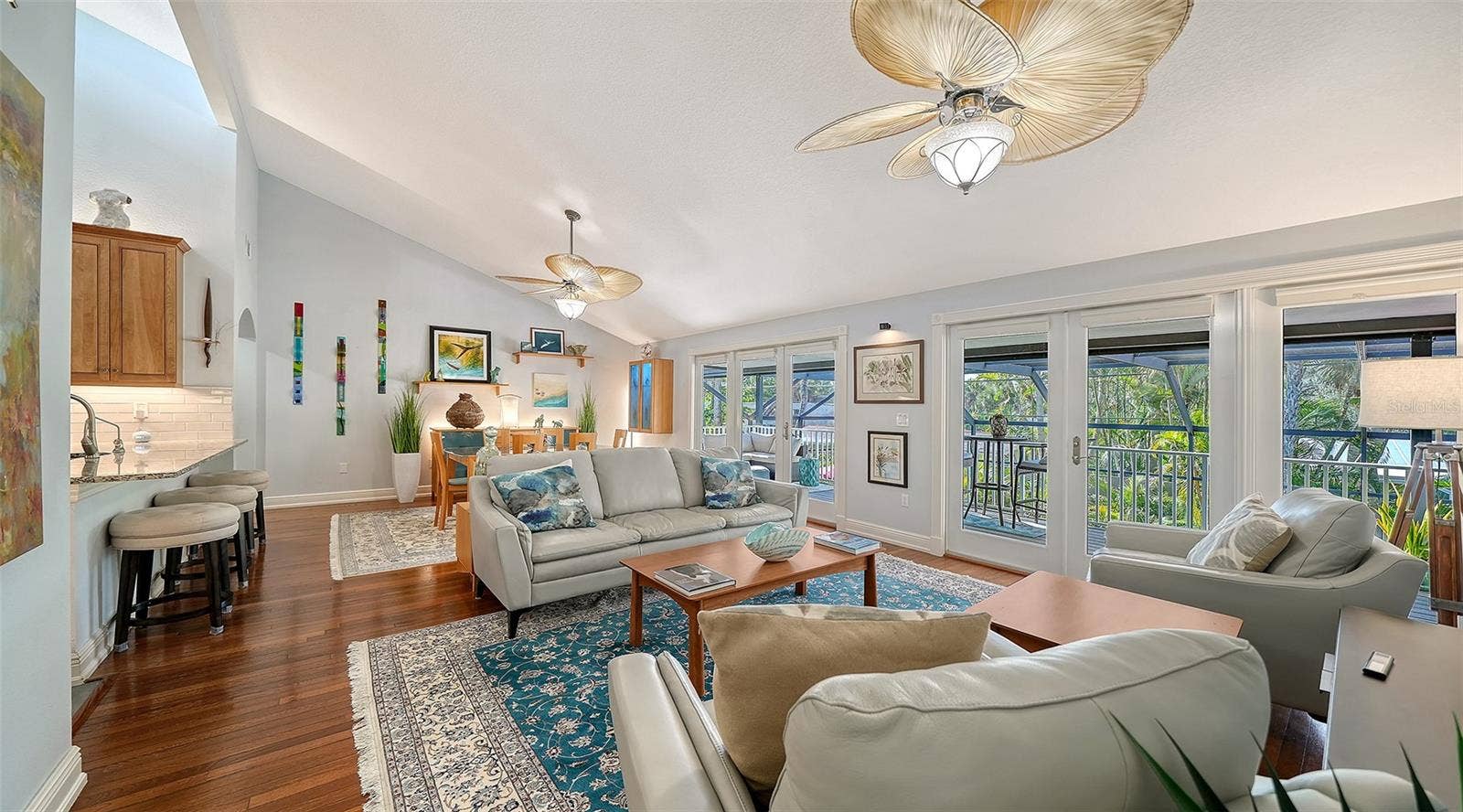 Spacious living room filled with natural light and opening to the covered balcony.