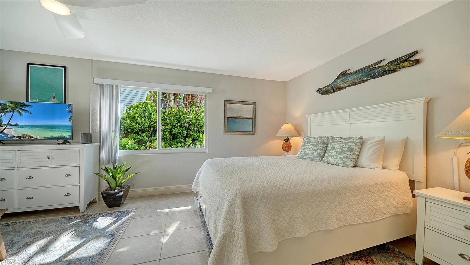Light-filled bedroom surrounded by tropical views.