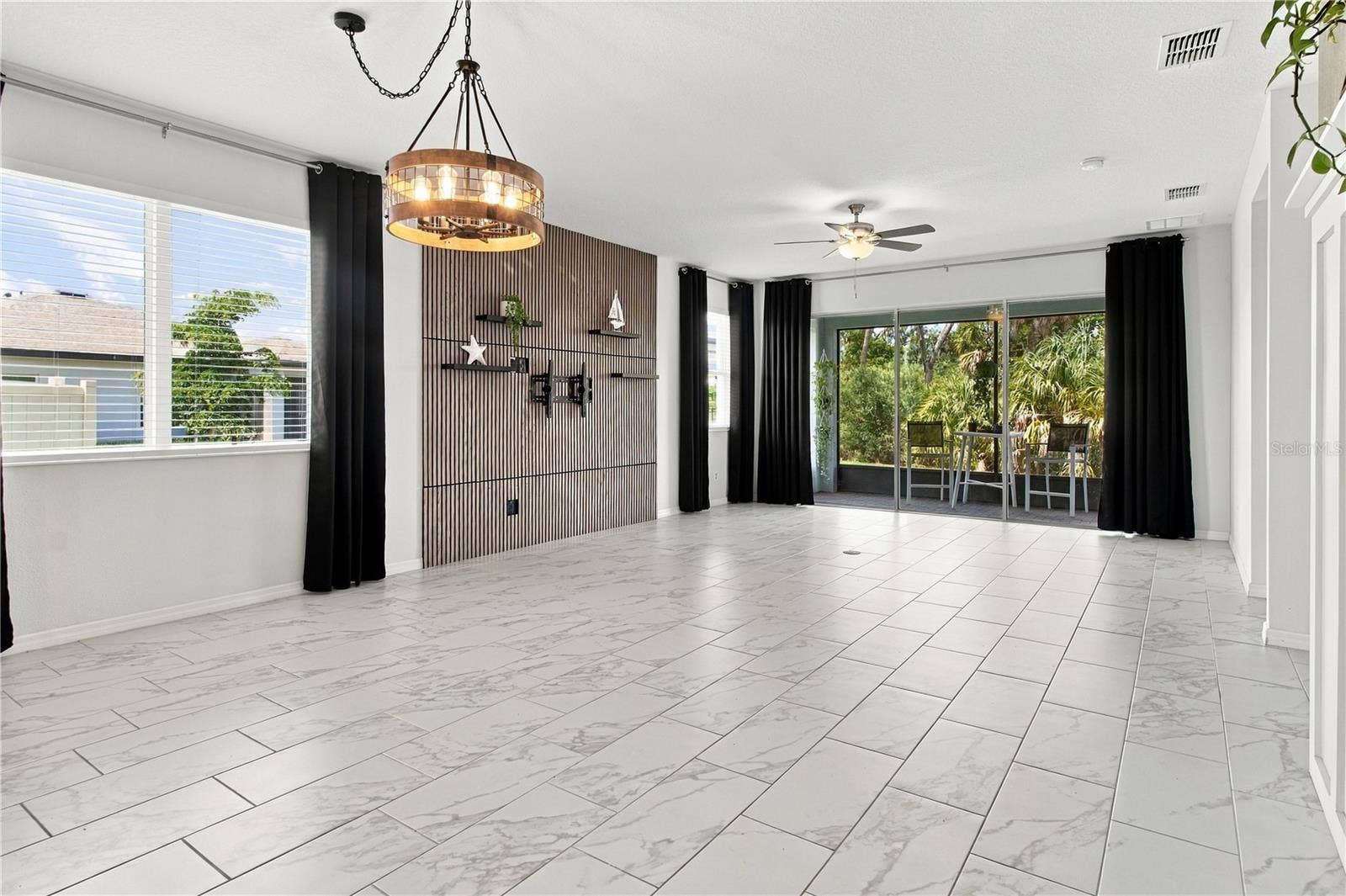 5706 MEZZANA RUN, Palmetto, FL 34221 Living Room w/Custom Wall Decor & Shelving