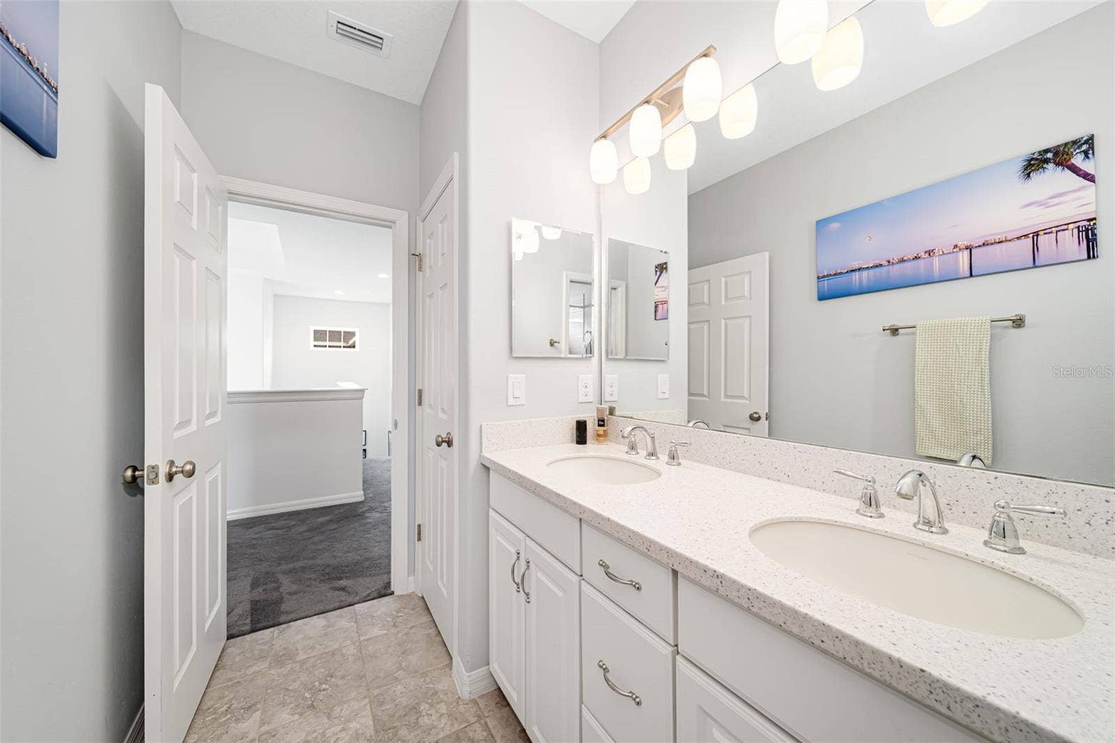 Bathroom with a spacious dual-sink vanity and tub-and-shower combination.