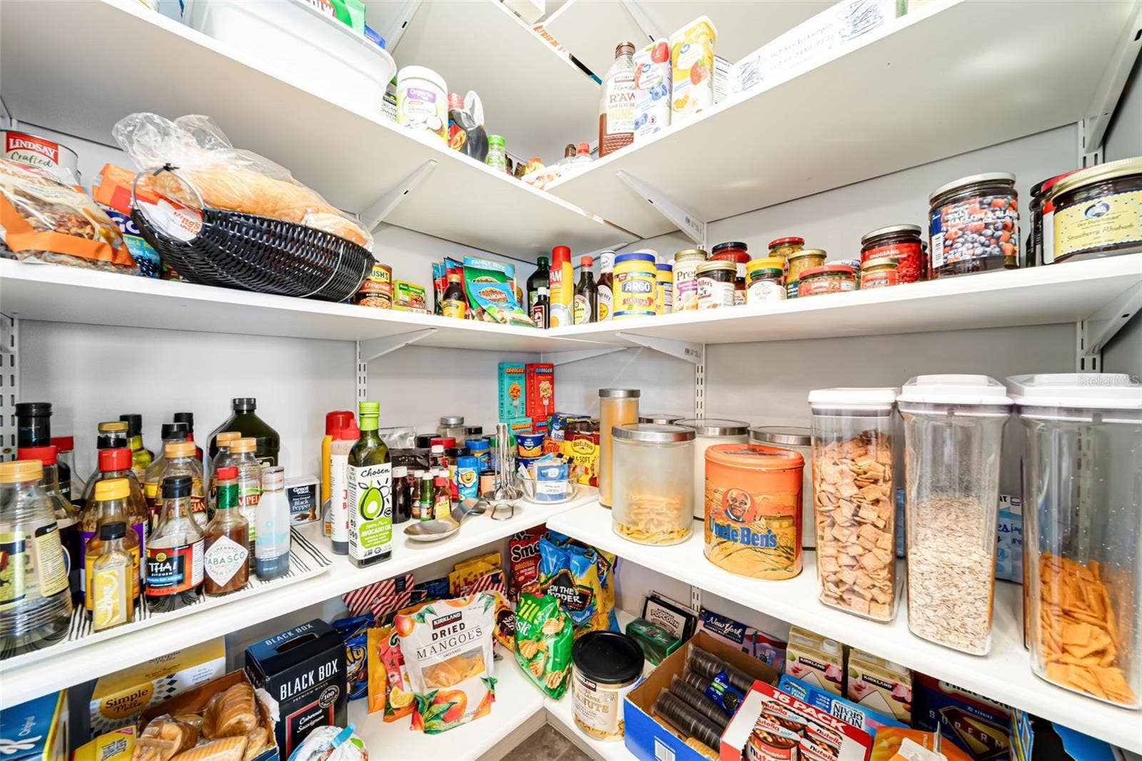 Convenient walk-in pantry with plenty of room for kitchen essentials.