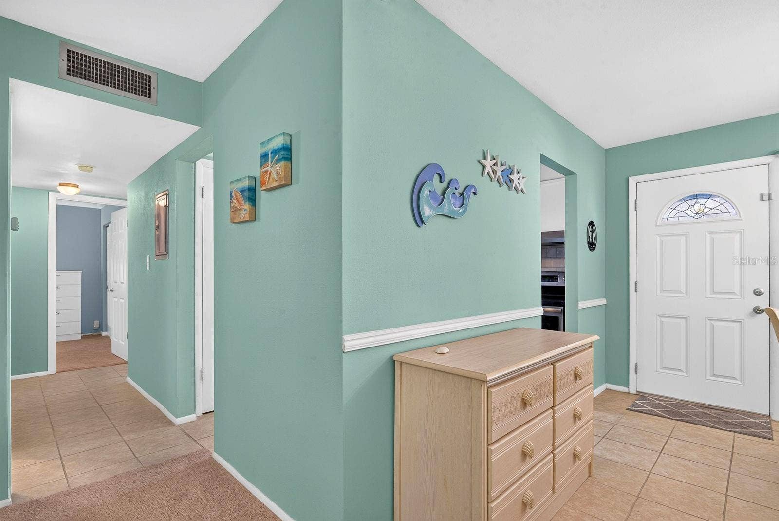 Entry featuring coastal neutral colors and space