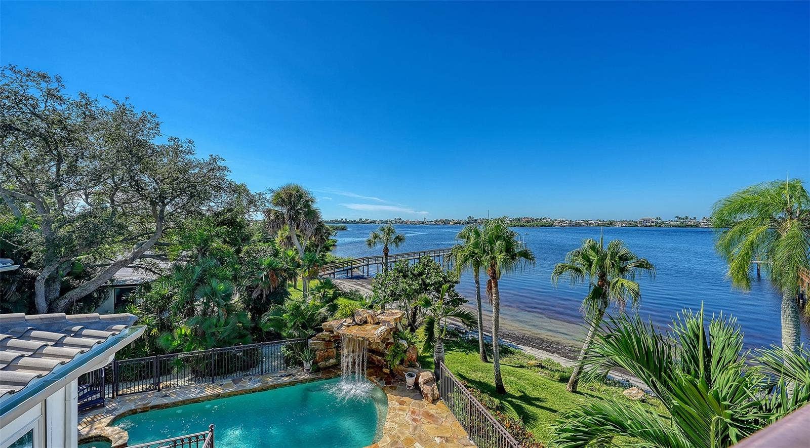 2115 LYCHEE LANE, Nokomis, FL 34275 view to the pool areas from owners suite and enjoy the sounds of the waterfall