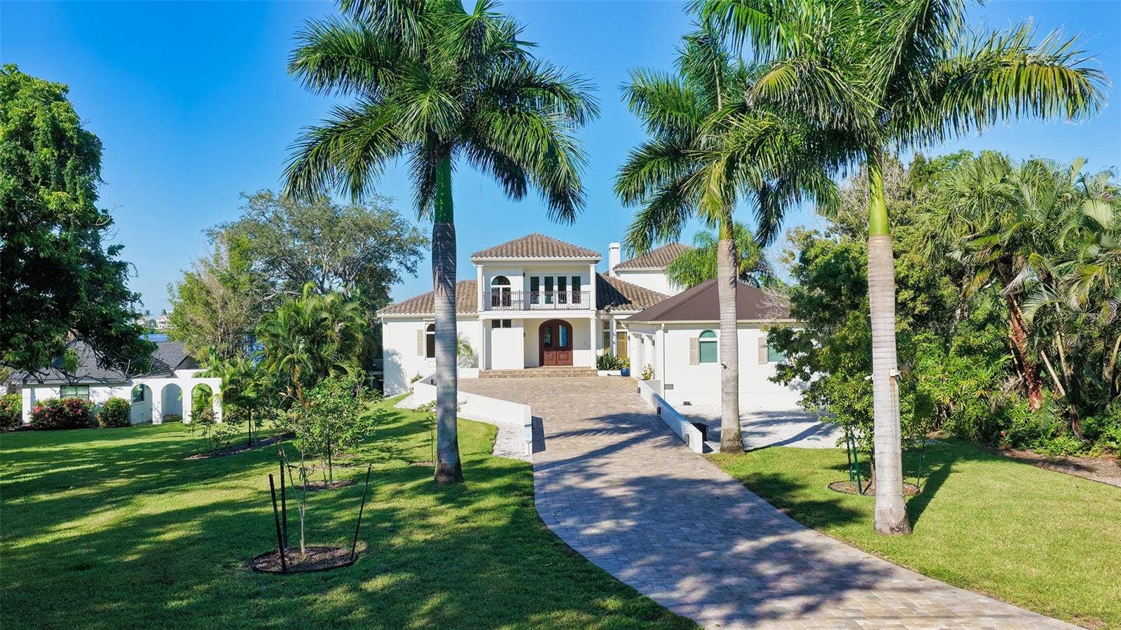 2115 LYCHEE LANE, Nokomis, FL 34275 Looking at the property from the private road, fruit trees line the paved driveway