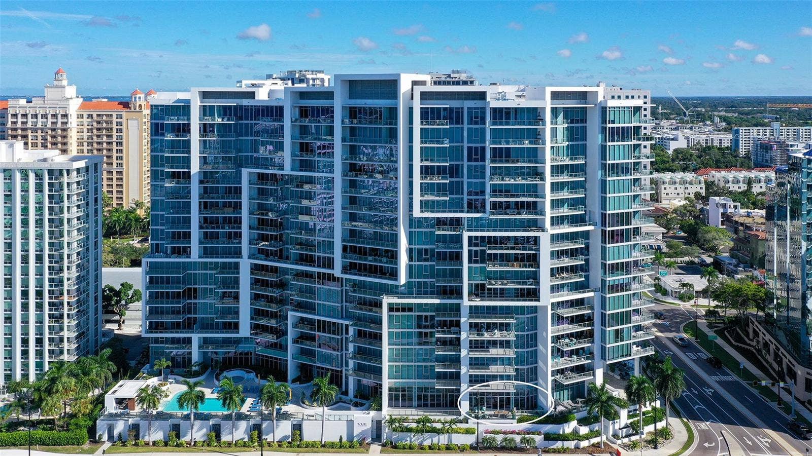 1155 N GULFSTREAM AVENUE, #207, Sarasota, FL 34236 An aerial perspective highlights The VUEs iconic architecture, showcasing its distinctive lines, elegant contours, and striking modern design.