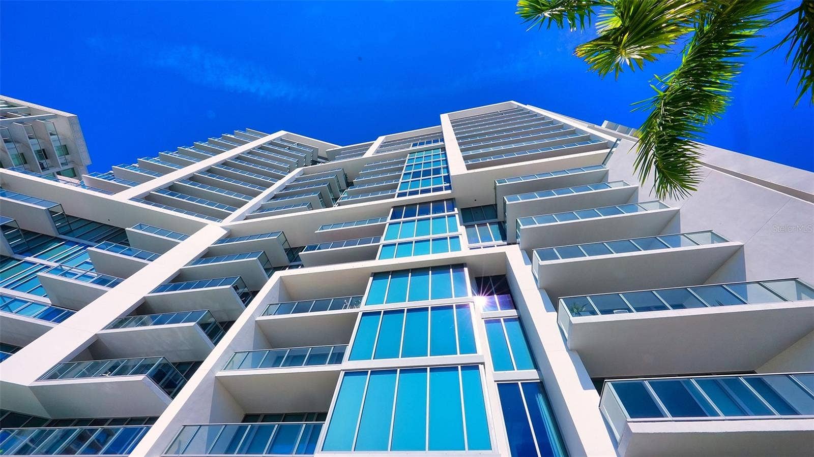 1155 N GULFSTREAM AVENUE, #207, Sarasota, FL 34236 A striking upward perspective showcases The VUEs iconic architecture, highlighting its distinctive design, soaring height, and impressive modern lines.