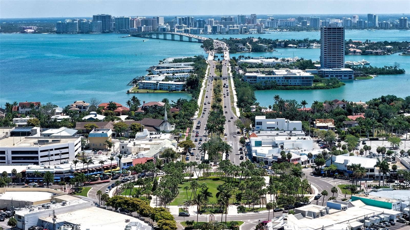 1155 N GULFSTREAM AVENUE, #207, Sarasota, FL 34236 A stunning aerial perspective from St. Armands Circle toward downtown Sarasota, showcasing the iconic skyline framed by sparkling Bay waters.