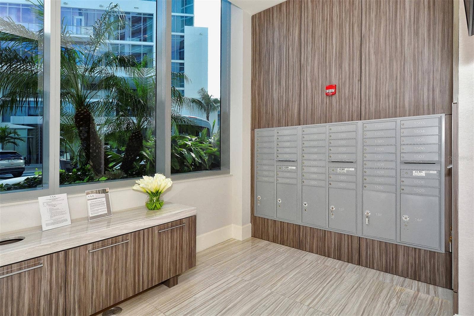 1155 N GULFSTREAM AVENUE, #207, Sarasota, FL 34236 A dedicated resident mailbox area featuring a digital display with upcoming community events and announcements for added convenience.