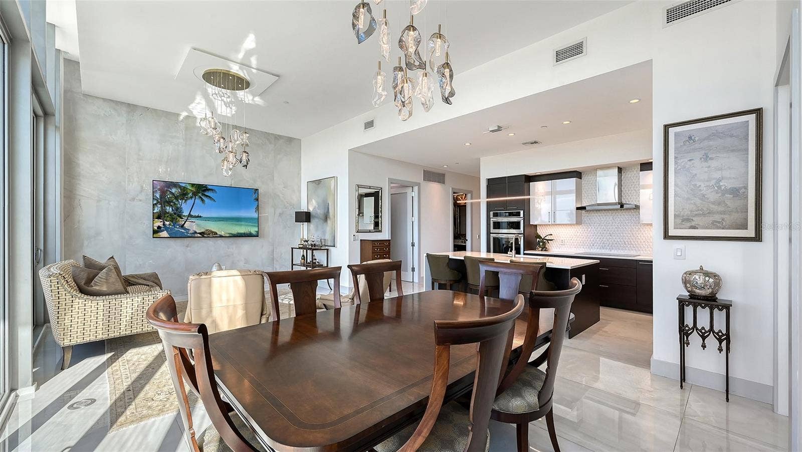 1155 N GULFSTREAM AVENUE, #207, Sarasota, FL 34236 An inviting dining area seamlessly connected to the kitchen and living room, perfect for memorable meals, lively game nights, and effortless entertaining.