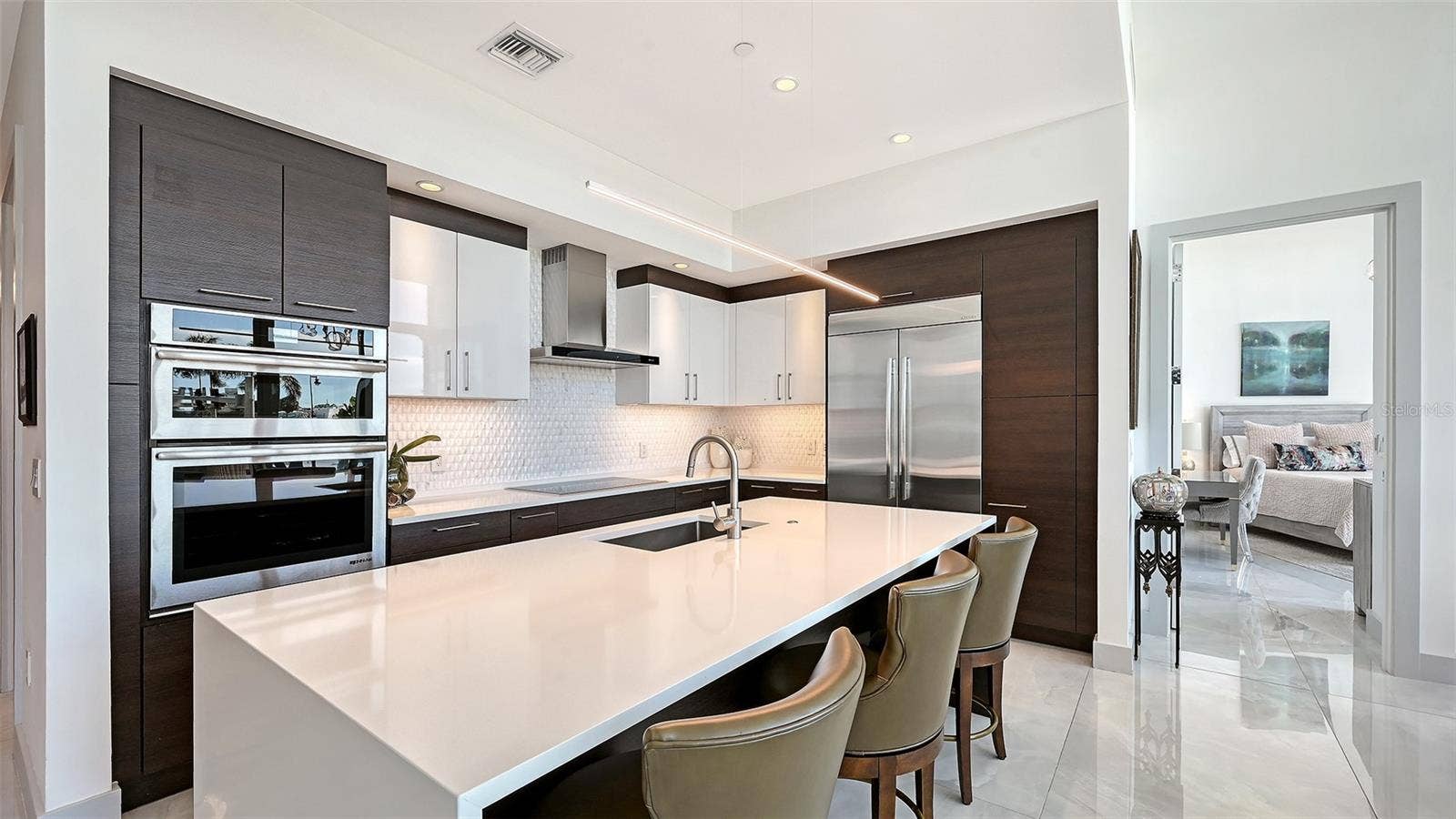 1155 N GULFSTREAM AVENUE, #207, Sarasota, FL 34236 A beautifully appointed kitchen featuring top-of-the-line appliances, perfect for the culinary enthusiast and sophisticated entertaining