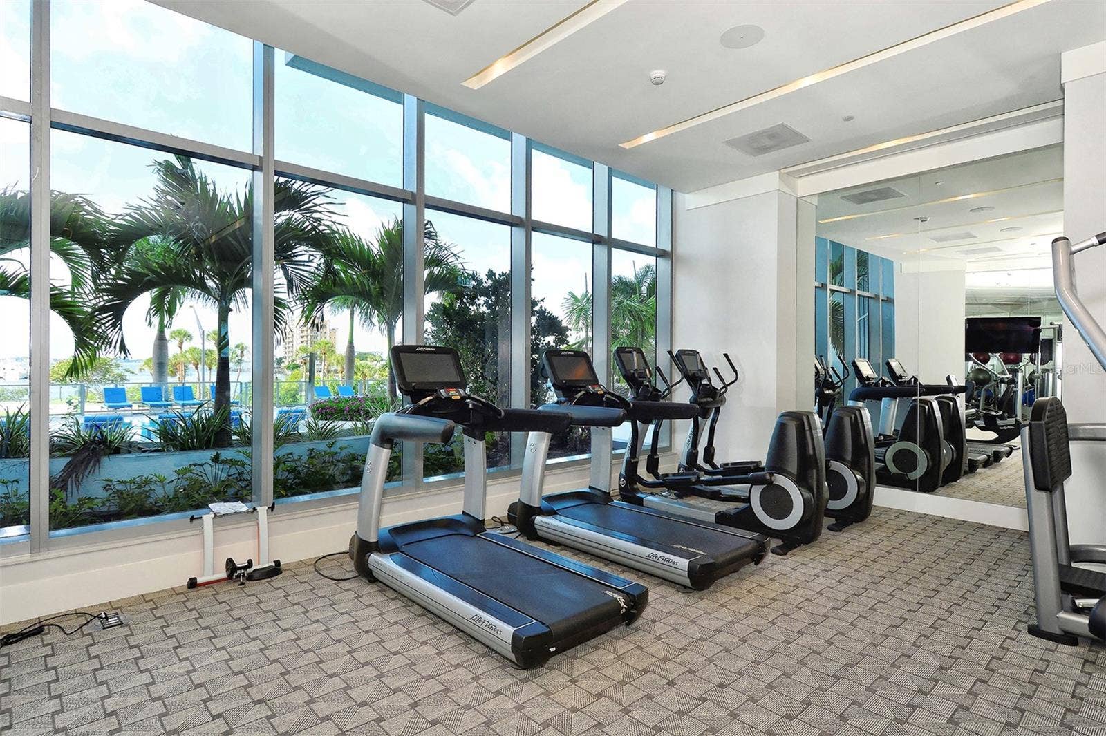 1155 N GULFSTREAM AVENUE, #207, Sarasota, FL 34236 A state-of-the-art fitness center featuring panoramic views of the resort-style pool and Sarasota Bay.