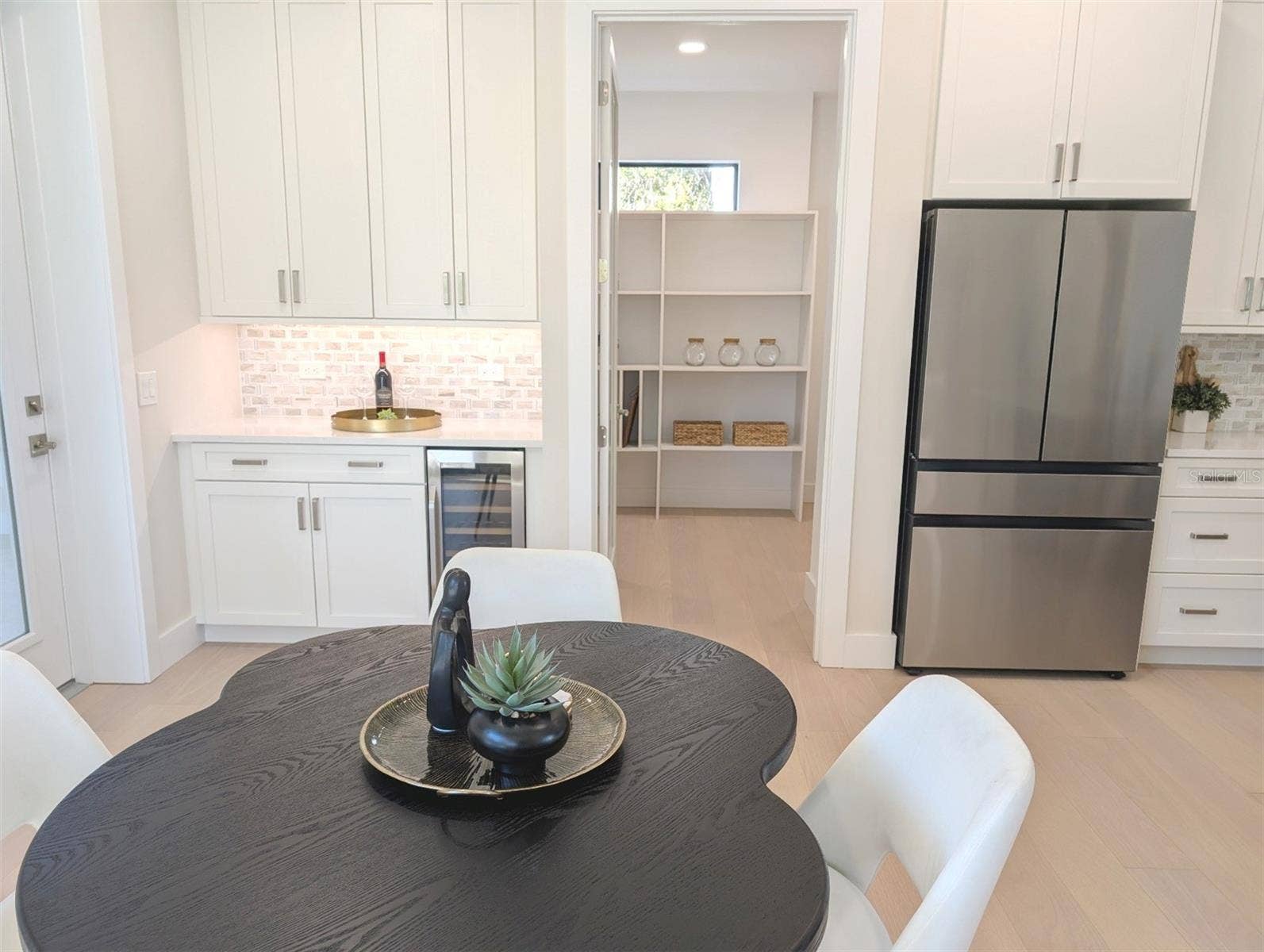 2110 MICHELE DRIVE, Sarasota, FL 34231 Coffee bar; spacious walk in pantry; under cabinet lighting; beverage cooler.