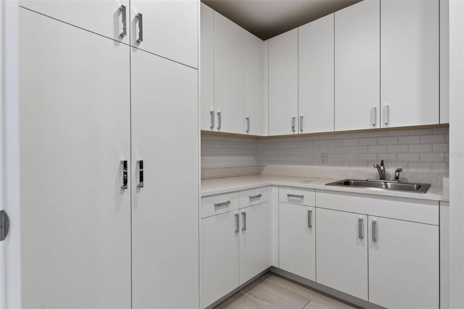 Walk-In Laundry Room with Ample Storage Cabinetry