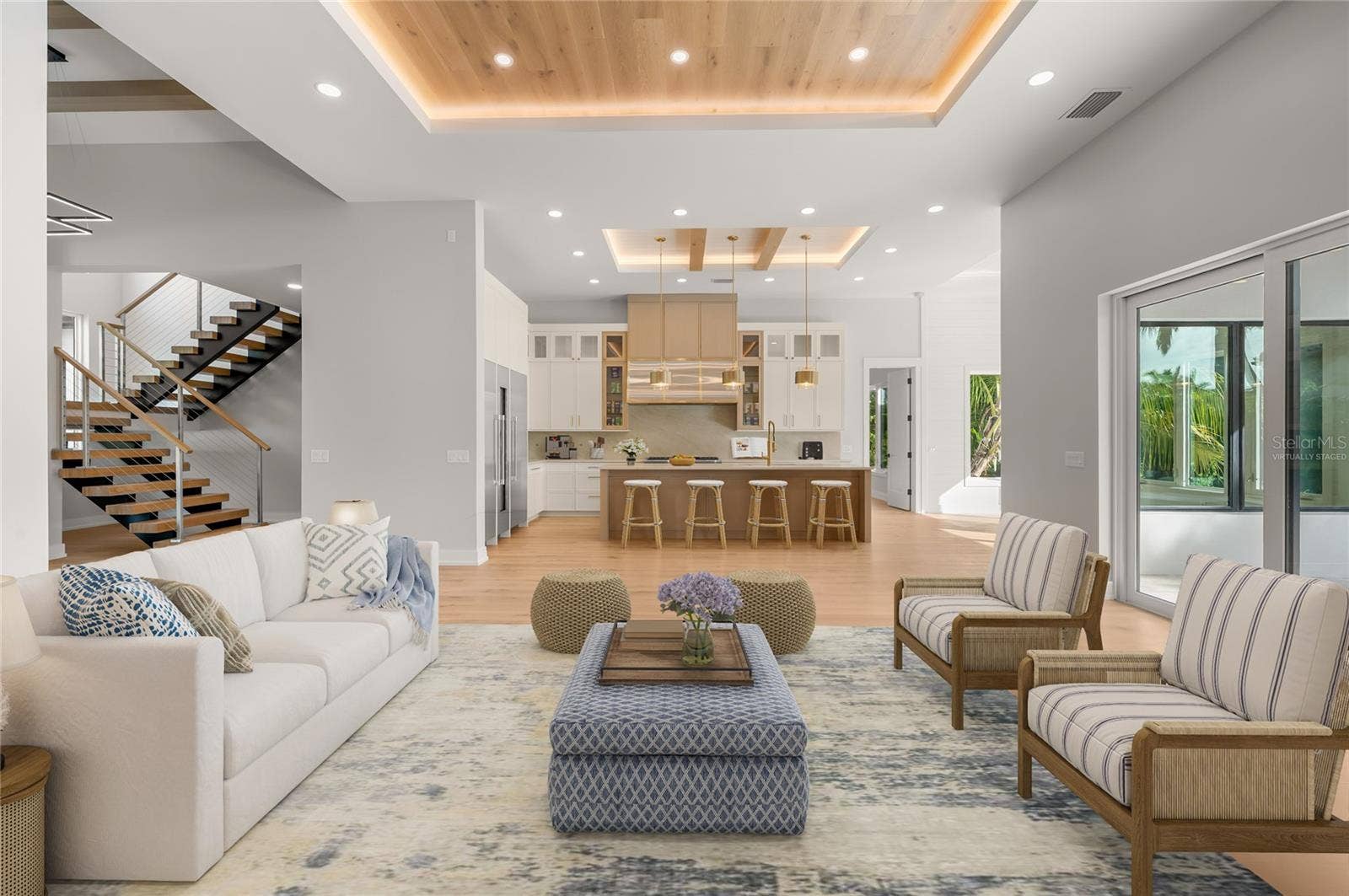3360 BAYOU SOUND, Longboat Key, FL 34228 Virtually staged family room featuring a custom inlaid wood ceiling, flowing seamlessly into the kitchen and dining area.