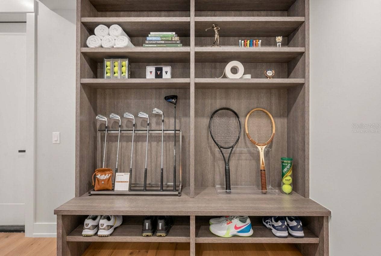 3360 BAYOU SOUND, Longboat Key, FL 34228 Virtually staged mudroom entry featuring custom built-ins with abundant storage for an active lifestyle.