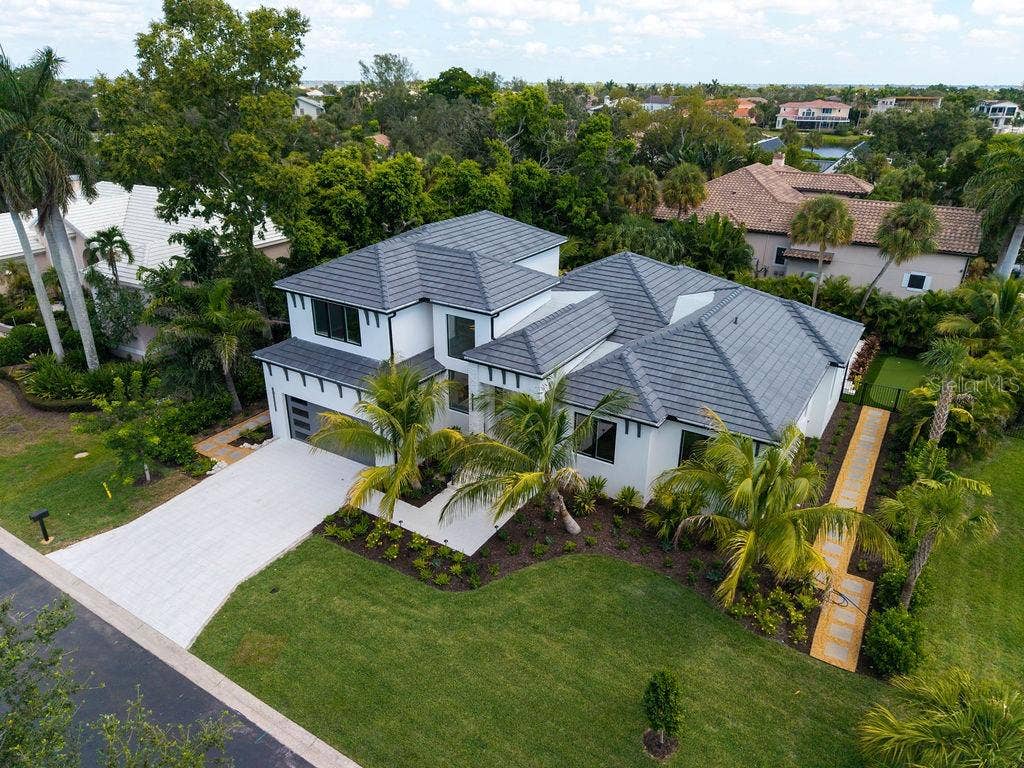3360 BAYOU SOUND, Longboat Key, FL 34228 Beautifully landscaped grounds with lush tropical plantings and a complete irrigation system.
