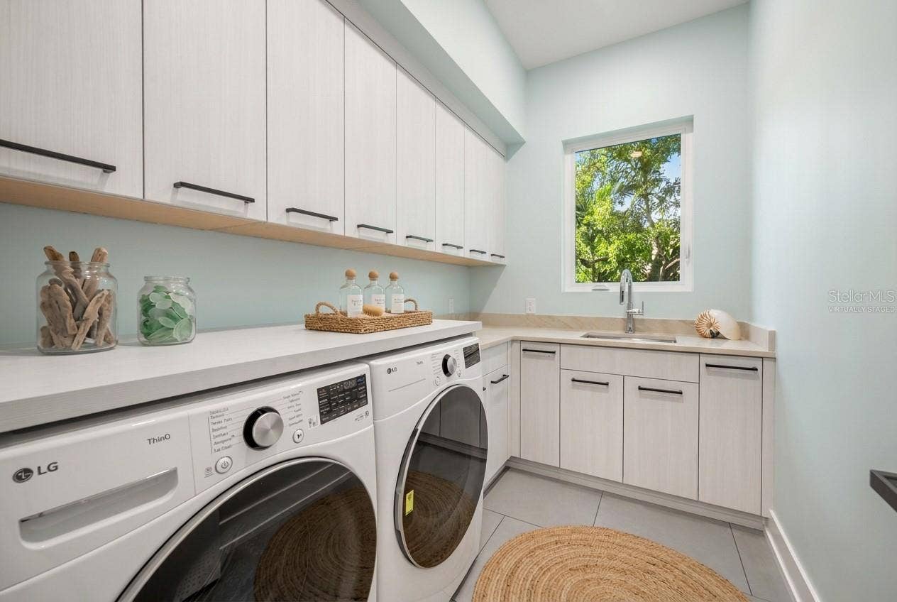 3360 BAYOU SOUND, Longboat Key, FL 34228 Virtually staged first-floor laundry room offering generous workspace, storage, and everyday convenience.