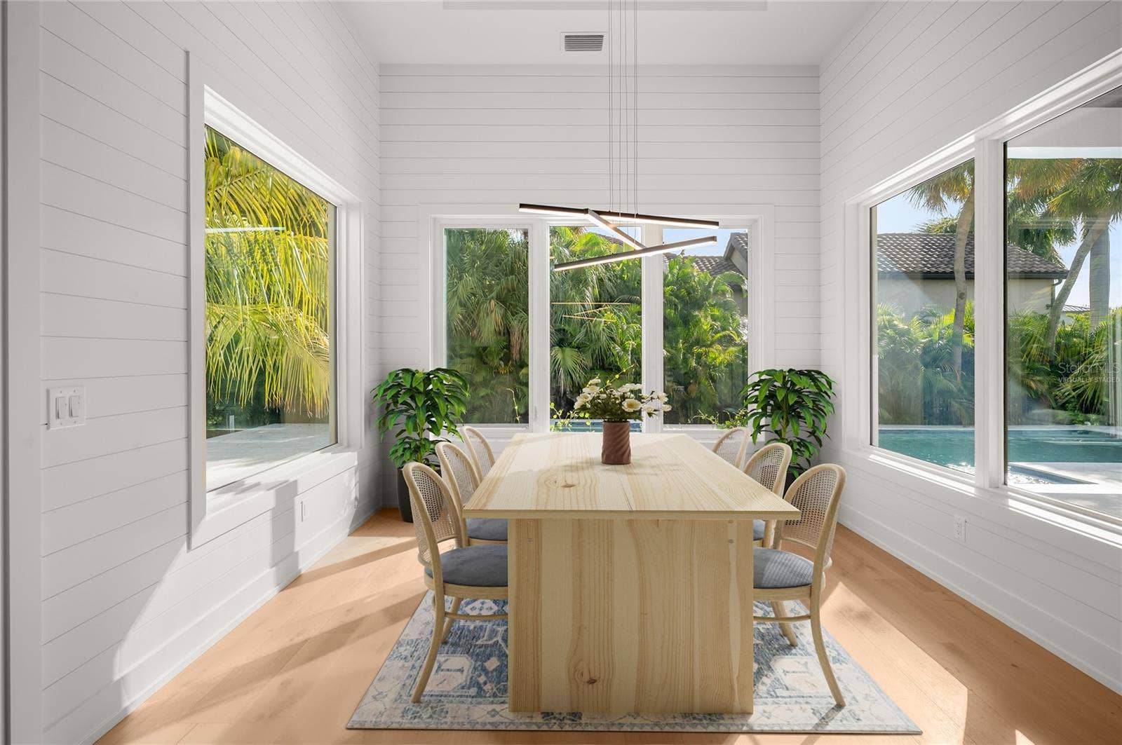 3360 BAYOU SOUND, Longboat Key, FL 34228 Virtually staged dining nook with elegant shiplap detailing, overlooking the private, beautifully landscaped backyard and pool.