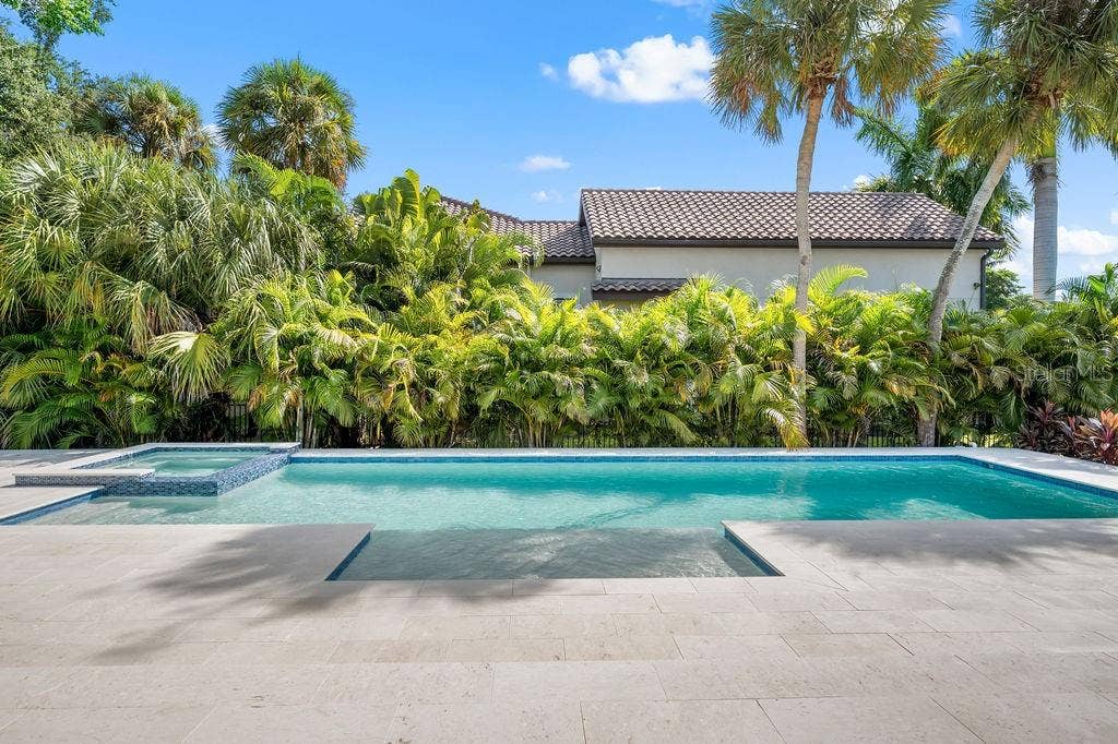 3360 BAYOU SOUND, Longboat Key, FL 34228 Heated saltwater pool has spa as well with plenty of sunlight and privacy.