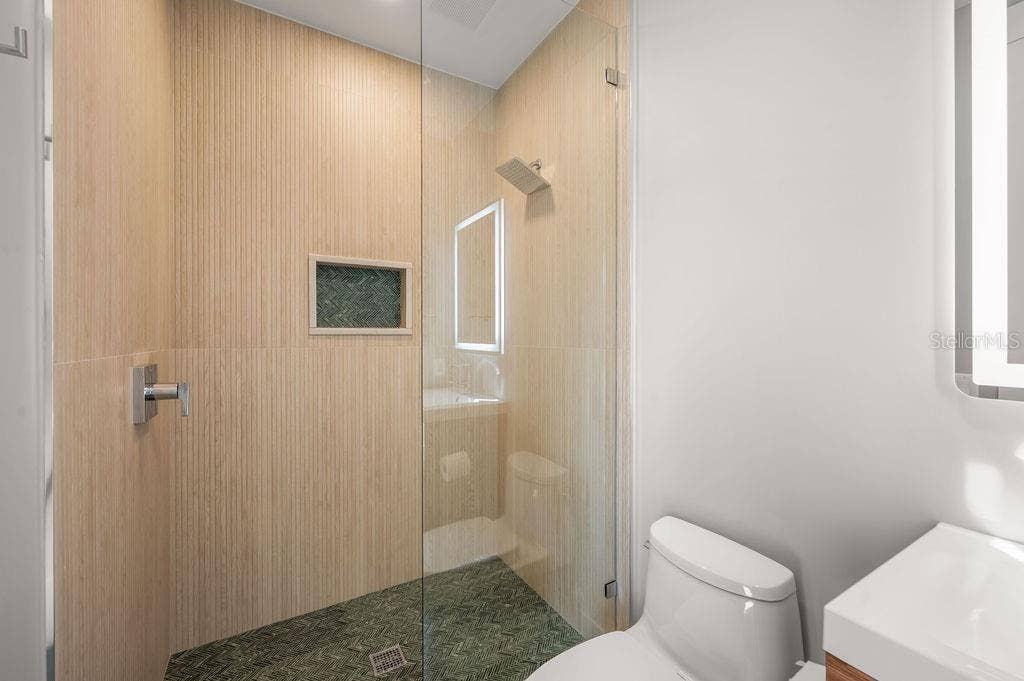 3360 BAYOU SOUND, Longboat Key, FL 34228 5th bedroom en suite features this custom designed walk in shower.