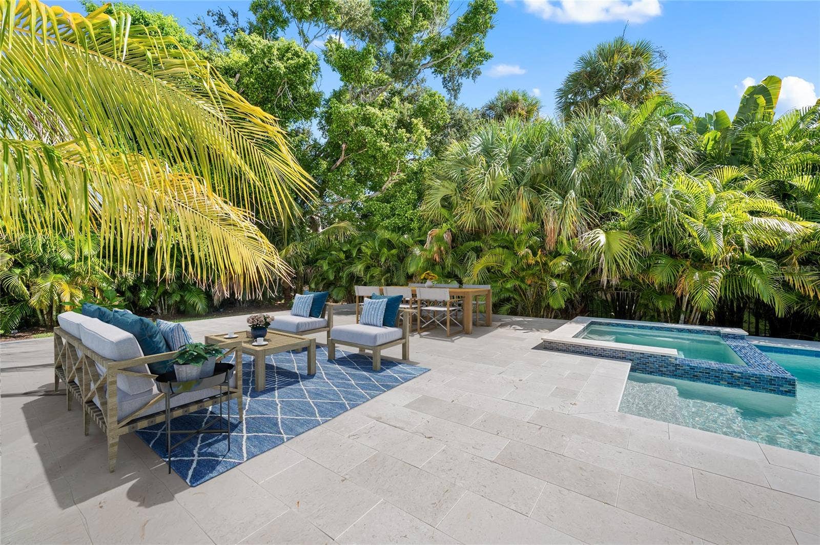 3360 BAYOU SOUND, Longboat Key, FL 34228 Virtually staged additional gathering space on pool deck in fenced and private back yard.