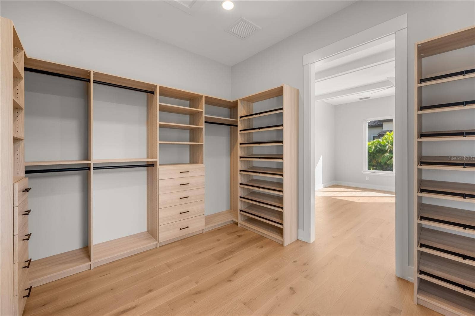 3360 BAYOU SOUND, Longboat Key, FL 34228 Primary bedroom walk in closet with built in closet system.