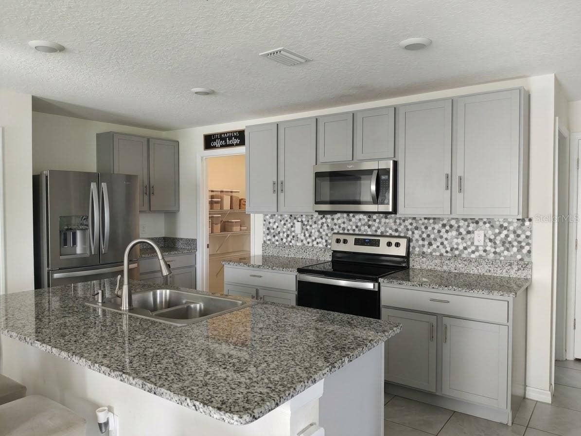 5058 GRANITE DUST PLACE, Palmetto, FL 34221 Open-concept kitchen "chef's triangle"