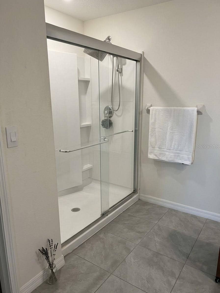 5058 GRANITE DUST PLACE, Palmetto, FL 34221 primary glass-enclosed walk-in shower