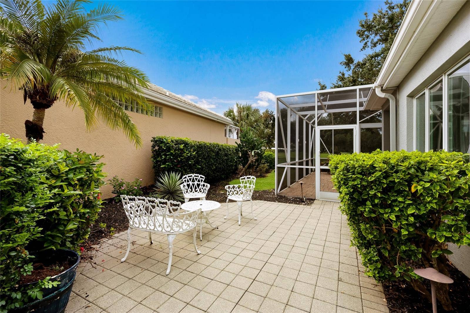 8728 52ND DRIVE E, Bradenton, FL 34211 Side paver patio extending the outdoor entertaining options