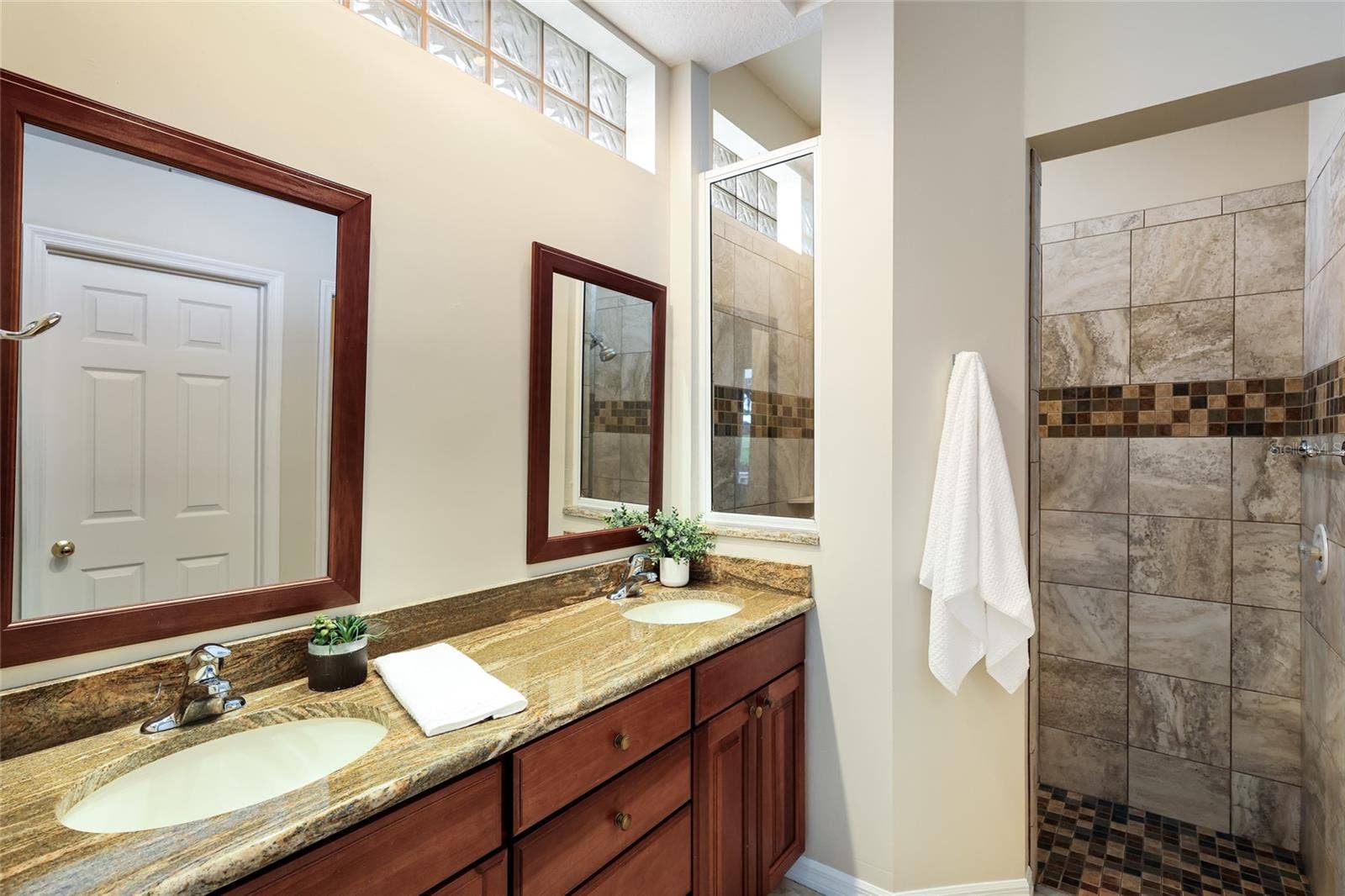 8728 52ND DRIVE E, Bradenton, FL 34211 Ensuite bathroom with dual sink vanity, walk-in tile shower, private water closet and sizable walk-in closet