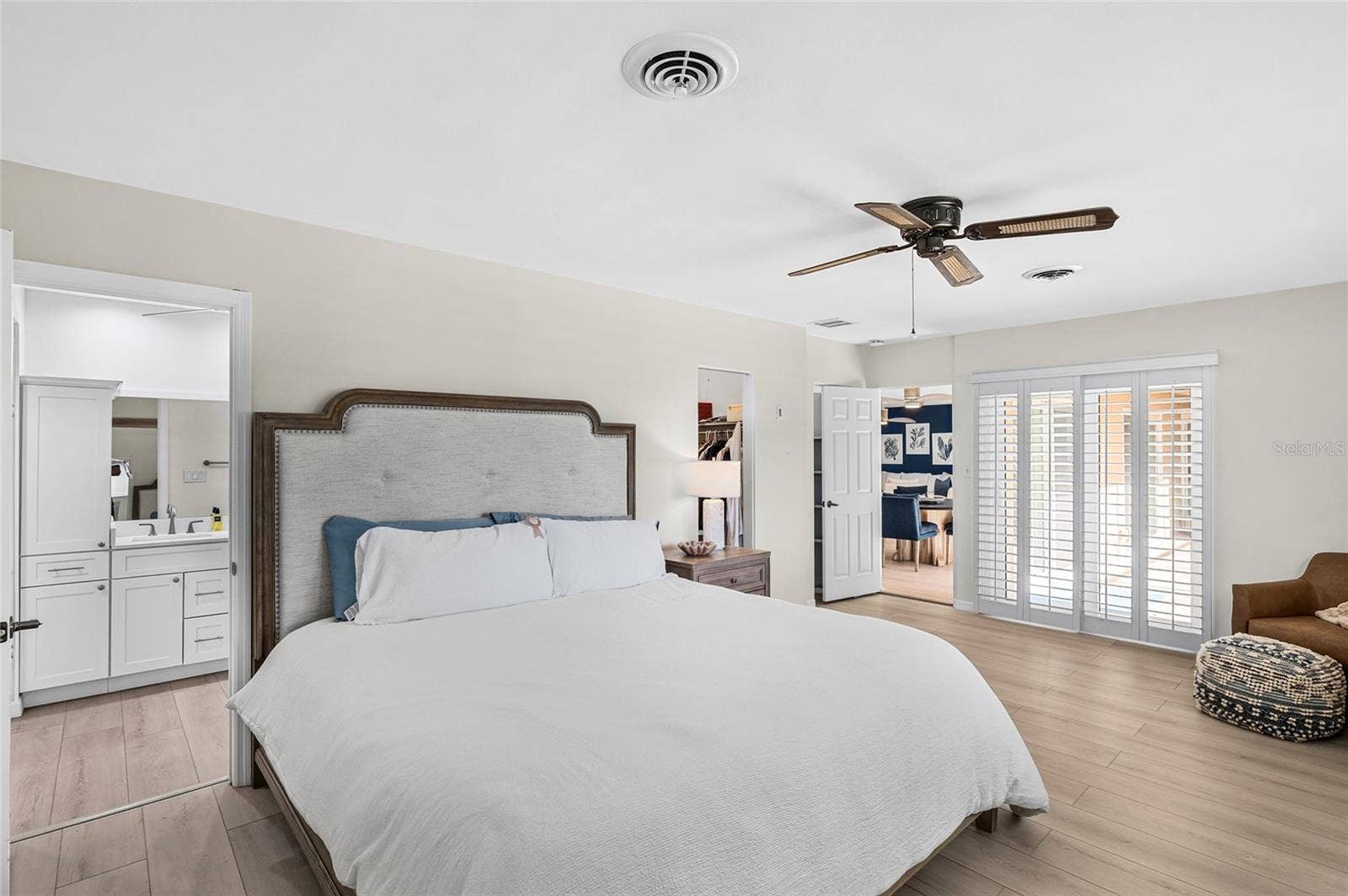 The first floor primary suite offers comfortable proportions, direct courtyard access and two walk in closets.