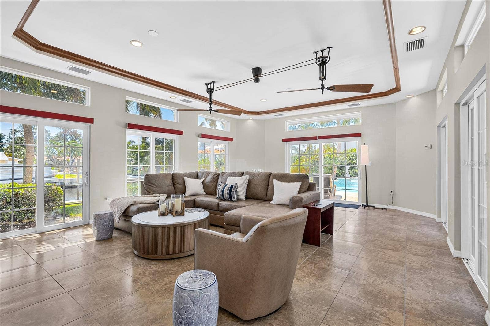 Spacious flex room features tall ceilings, abundant natural light and easy access to the outdoor living areas.