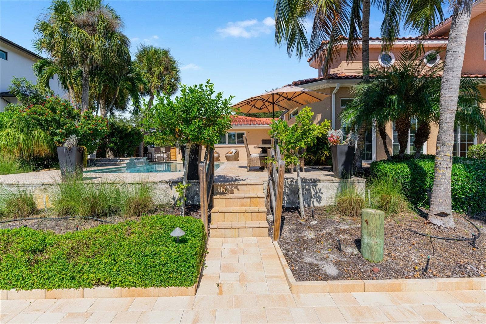 Paver Path To Waterfront, highlighting the connection to the water and Siesta Key lifestyle.