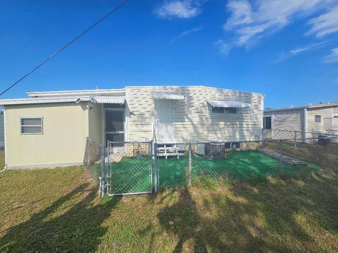 5619 BAYSHORE ROAD, #115, Palmetto, FL 34221 REAR OF MOBILE HOME SHOWING FENCED AREA.