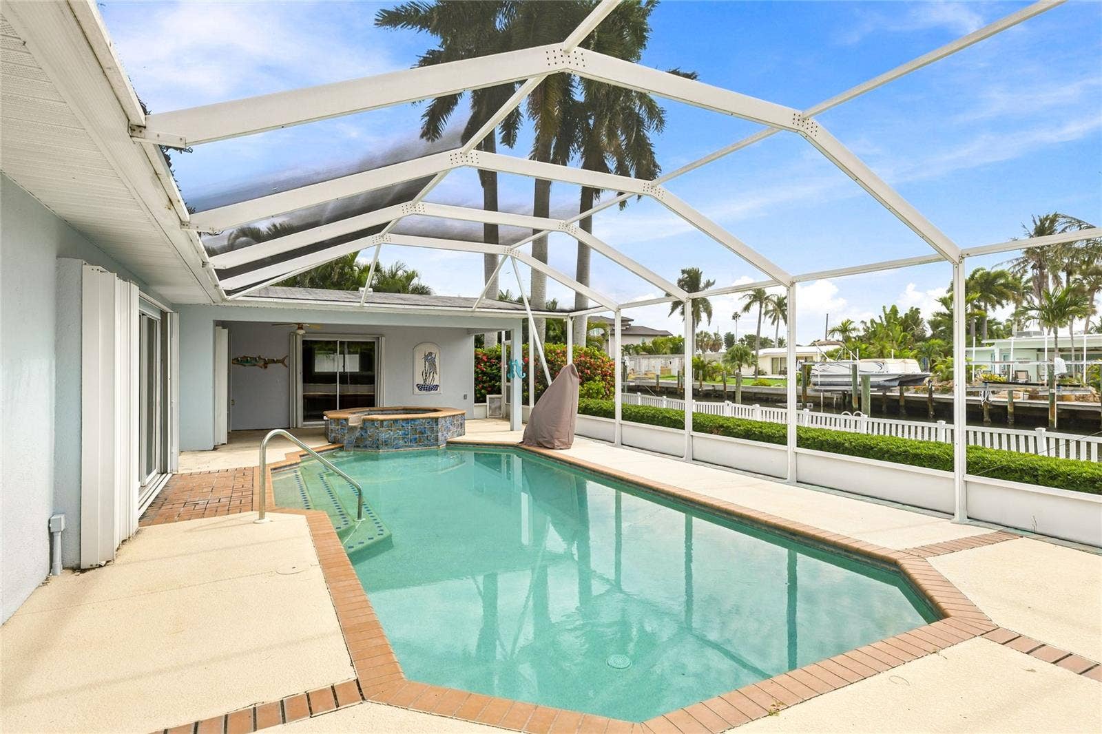 517 71ST STREET, Holmes Beach, FL 34217 Screened pool and spa area near the dock and canal