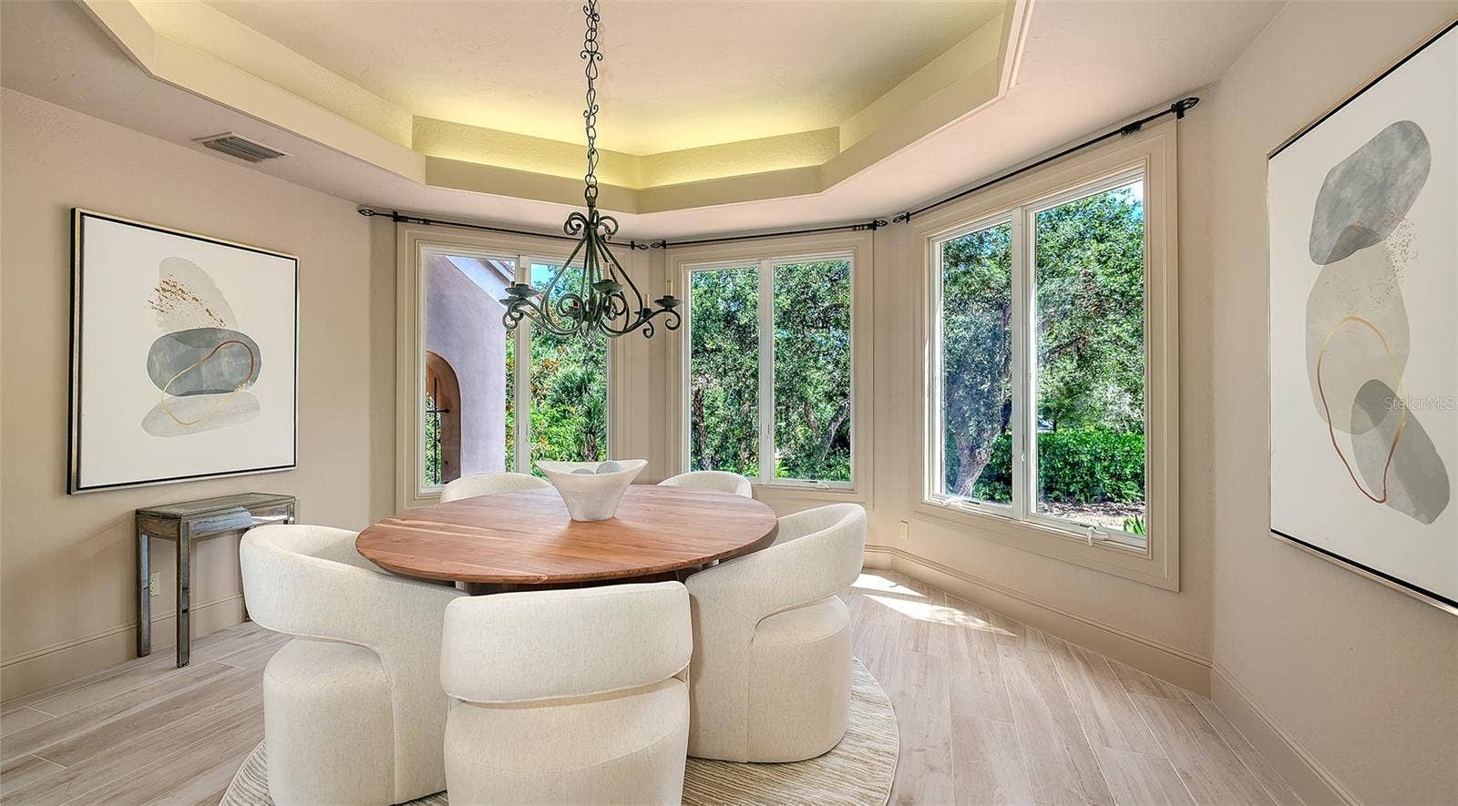 168 COASTAL HAMMOCK COURT, Osprey, FL 34229 A beautifully defined dining room offers an intimate setting enhanced by a tray ceiling, chandelier and abundant natural light.